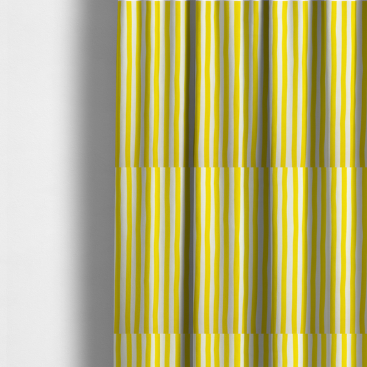 The fabric used to create these made-to-measure curtains is a white fabric patterned with vertical, hand-drawn yellow stripes that feature a slight, organic waviness.