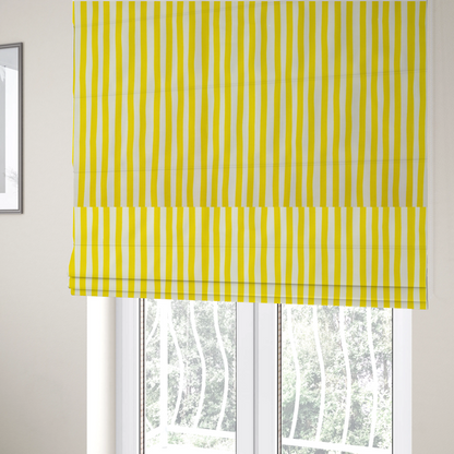 The fabric used to create these Roman blinds is a white fabric patterned with vertical, hand-drawn yellow stripes that feature a slight, organic waviness.
