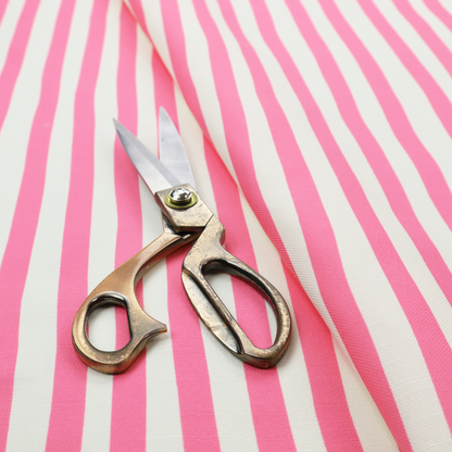 A white fabric patterned with vertical, hand-drawn pink stripes that feature a slight, organic waviness.