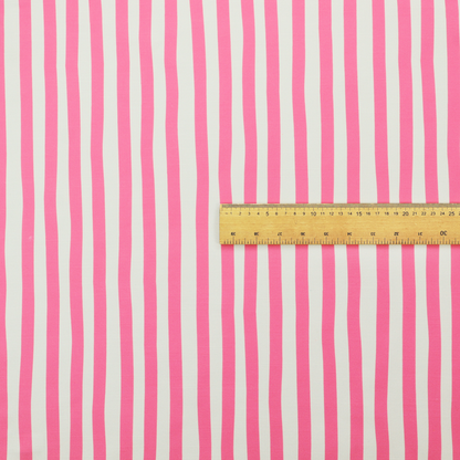 A white fabric patterned with vertical, hand-drawn pink stripes that feature a slight, organic waviness.