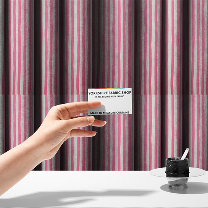 The fabric used to create these made-to-measure curtains is a white fabric patterned with vertical, hand-drawn pink stripes that feature a slight, organic waviness.