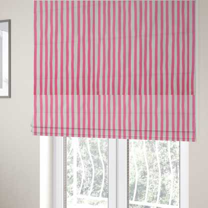 The fabric used to create these Roman blinds is a white fabric patterned with vertical, hand-drawn pink stripes that feature a slight, organic waviness.