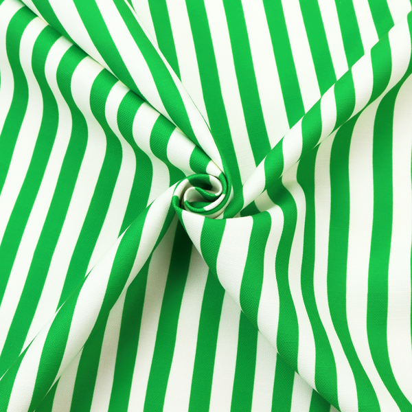 A white fabric patterned with vertical, hand-drawn green stripes that feature a slight, organic waviness.