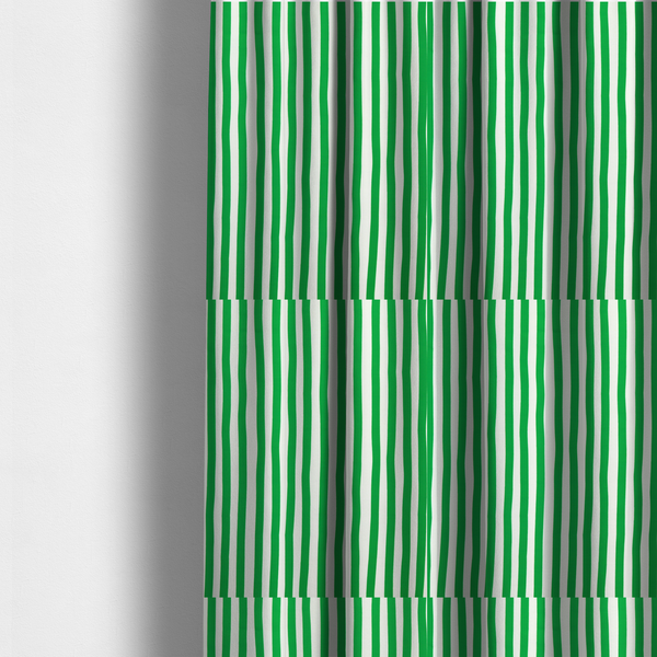 The fabric used to create these made-to-measure curtains is a white fabric patterned with vertical, hand-drawn green stripes that feature a slight, organic waviness.