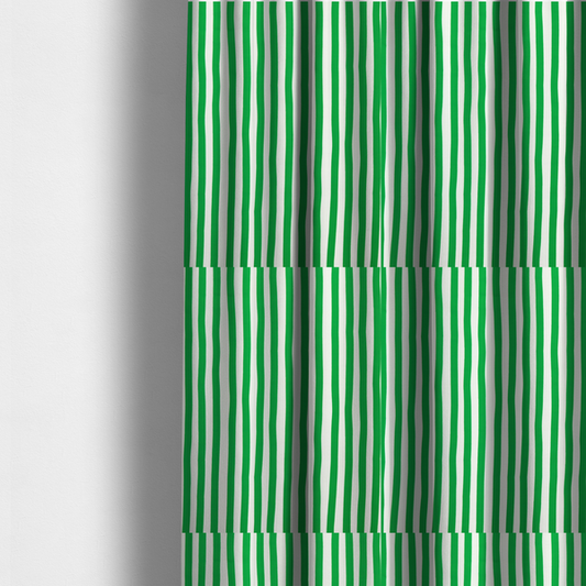 The fabric used to create these made-to-measure curtains is a white fabric patterned with vertical, hand-drawn green stripes that feature a slight, organic waviness.
