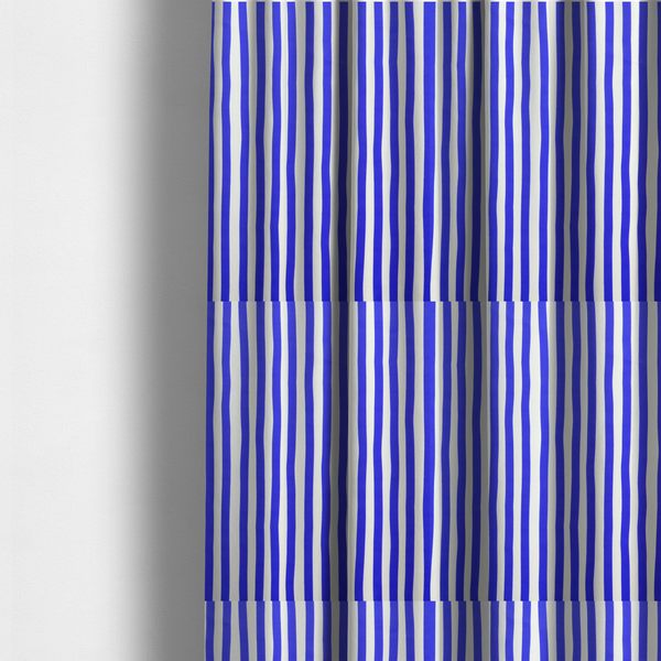 The fabric used to create these made-to-measure curtains is a white fabric patterned with vertical, hand-drawn blue stripes that feature a slight, organic waviness.   