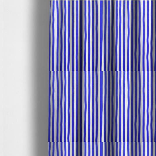The fabric used to create these made-to-measure curtains is a white fabric patterned with vertical, hand-drawn blue stripes that feature a slight, organic waviness.   