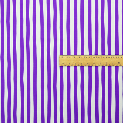 A white fabric patterned with vertical, hand-drawn purple stripes that feature a slight, organic waviness.