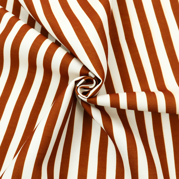 A white fabric patterned with vertical, hand-drawn brown stripes that feature a slight, organic waviness.