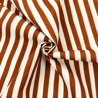 A white fabric patterned with vertical, hand-drawn brown stripes that feature a slight, organic waviness.