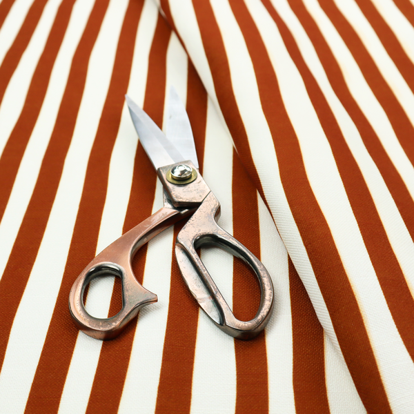 A white fabric patterned with vertical, hand-drawn brown stripes that feature a slight, organic waviness.