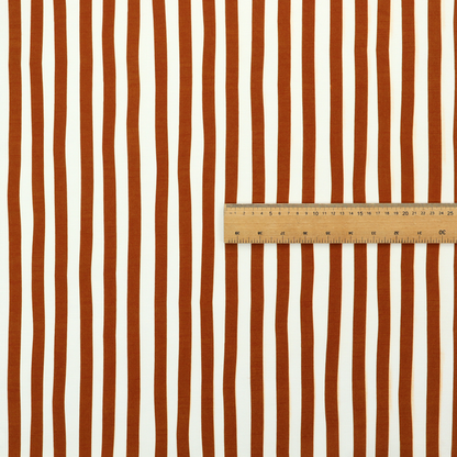 A white fabric patterned with vertical, hand-drawn brown stripes that feature a slight, organic waviness.