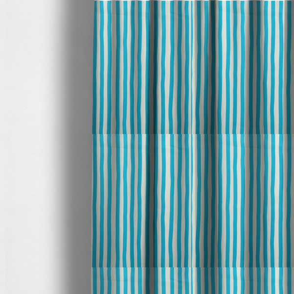 The fabric used to create these made-to-measure curtains is a white fabric patterned with vertical, hand-drawn light blue stripes that feature a slight, organic waviness.