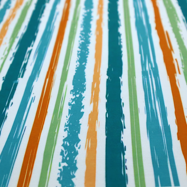A white fabric patterned with multi-coloured vertical, hand-drawn stripes in teal, green, blue, and orange with a slight, organic waviness.