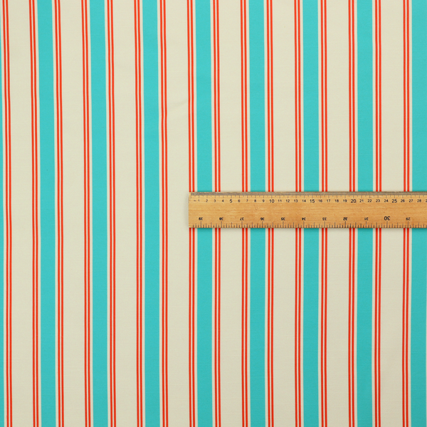 A white fabric patterned with vertical, hand-drawn turquoise and red double stripes that feature a slight, organic waviness.