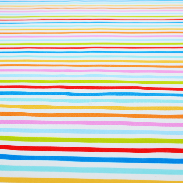 A white fabric patterned with horizontal, hand-drawn multi-coloured stripes in pink, blue, green, red, yellow, and orange that feature a slight, organic waviness.   