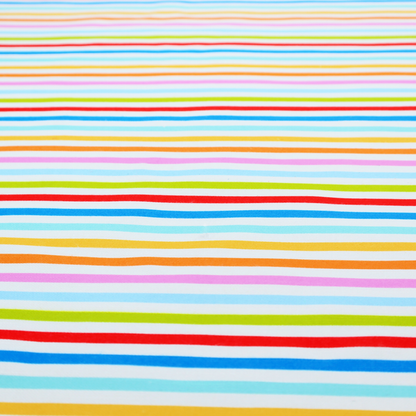 A white fabric patterned with horizontal, hand-drawn multi-coloured stripes in pink, blue, green, red, yellow, and orange that feature a slight, organic waviness.   