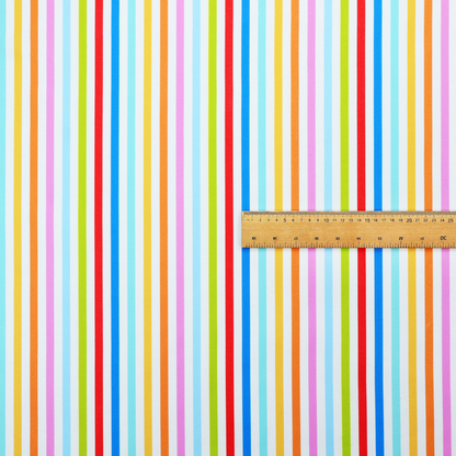 A white fabric patterned with horizontal, hand-drawn multi-coloured stripes in pink, blue, green, red, yellow, and orange that feature a slight, organic waviness.   