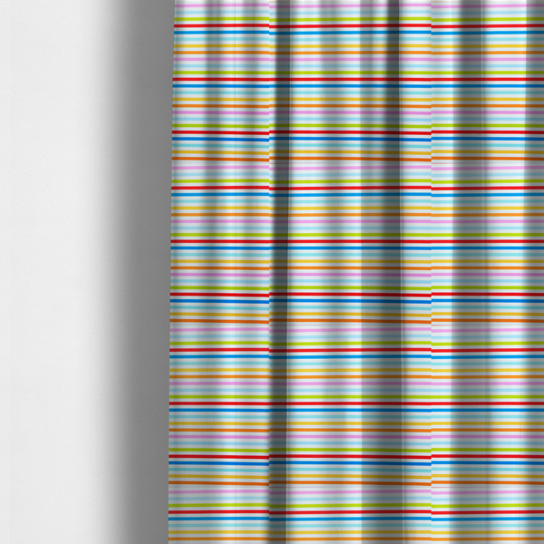 The fabric used to create these made-to-measure curtains is a white fabric patterned with horizontal, hand-drawn multi-coloured stripes in pink, blue, green, red, yellow, and orange that feature a slight, organic waviness.   