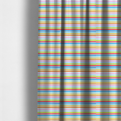 The fabric used to create these made-to-measure curtains is a white fabric patterned with horizontal, hand-drawn multi-coloured stripes in pink, blue, green, red, yellow, and orange that feature a slight, organic waviness.   