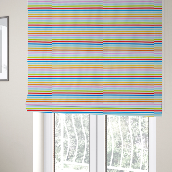 The fabric used to create these Roman blinds is a white fabric patterned with horizontal, hand-drawn multi-coloured stripes in pink, blue, green, red, yellow, and orange that feature a slight, organic waviness.   