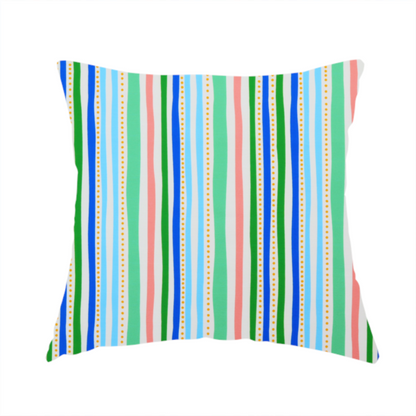 The fabric used to create this handmade cushion is a white fabric patterned with vertical, hand-drawn multi-coloured stripes in green, blue, pink, and light blue alongside dotted lines that feature an organic waviness.