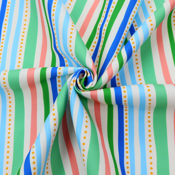 A white fabric patterned with vertical, hand-drawn multi-coloured stripes in green, blue, pink, and light blue alongside dotted lines that feature an organic waviness.