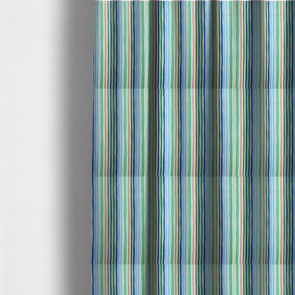 The fabric used to create these made-to-measure curtains is a white fabric patterned with vertical, hand-drawn multi-coloured stripes in green, blue, pink, and light blue alongside dotted lines that feature an organic waviness.