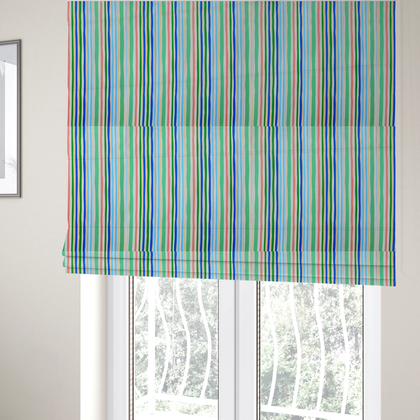 The fabric used to create these Roman blinds is a white fabric patterned with vertical, hand-drawn multi-coloured stripes in green, blue, pink, and light blue alongside dotted lines that feature an organic waviness.