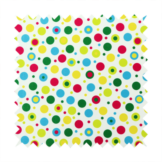 A playful fabric pattern featuring scattered polka dots and concentric circles in various sizes and colours, including pink, blue, green, yellow, and lime on a white background.