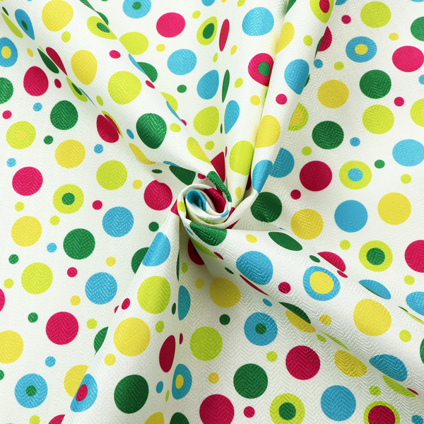 A playful fabric pattern featuring scattered polka dots and concentric circles in various sizes and colours, including pink, blue, green, yellow, and lime on a white background.