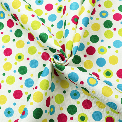 A playful fabric pattern featuring scattered polka dots and concentric circles in various sizes and colours, including pink, blue, green, yellow, and lime on a white background.