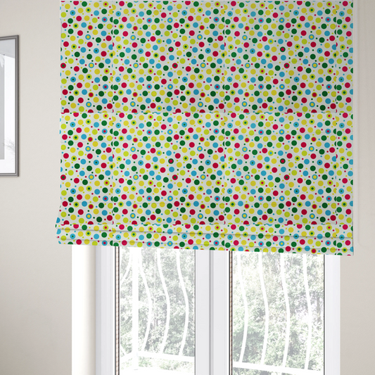 The fabric used to create these Roman blinds is a playful fabric pattern featuring scattered polka dots and concentric circles in various sizes and colours, including pink, blue, green, yellow, and lime on a white background.