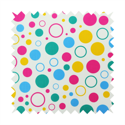 A fun and colourful fabric pattern featuring random solid and hollow polka dots in pink, teal, yellow, and blue on a white background.