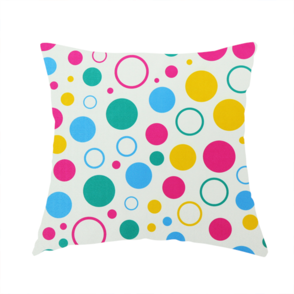 The fabric used to create this handmade cushion is a fun and colourful fabric pattern featuring random solid and hollow polka dots in pink, teal, yellow, and blue on a white background.