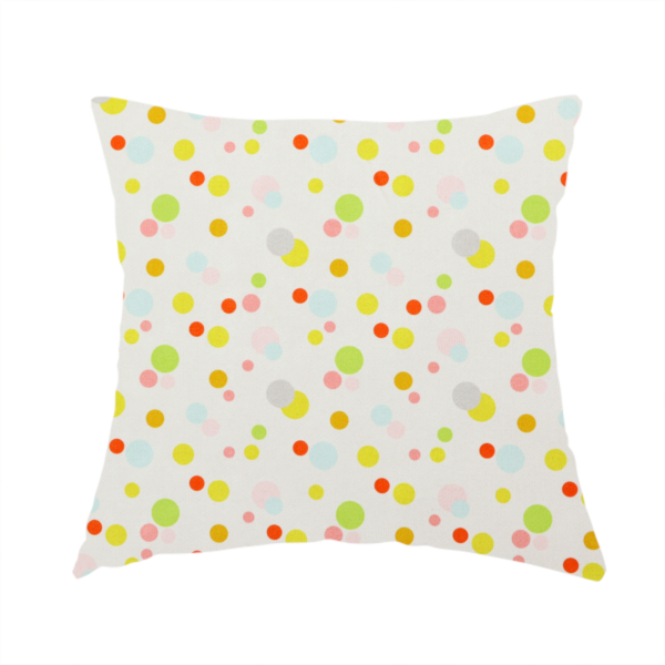 The fabric used to create this handmade cushion is a subtle fabric pattern featuring scattered pastel and bright polka dots in shades of yellow, orange, light green, grey, and soft blue on a white background.
