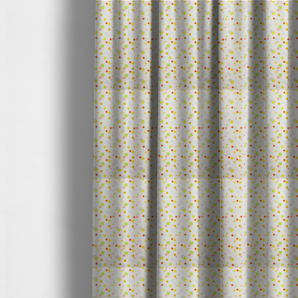 The fabric used to create these made-to-measure curtains is a subtle fabric pattern featuring scattered pastel and bright polka dots in shades of yellow, orange, light green, grey, and soft blue on a white background.
