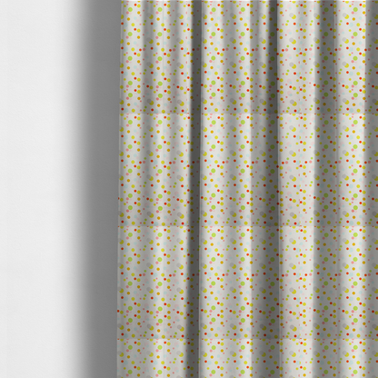 The fabric used to create these made-to-measure curtains is a subtle fabric pattern featuring scattered pastel and bright polka dots in shades of yellow, orange, light green, grey, and soft blue on a white background.
