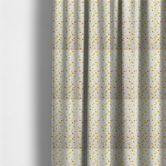 The fabric used to create these made-to-measure curtains is a subtle fabric pattern featuring scattered pastel and bright polka dots in shades of yellow, orange, light green, grey, and soft blue on a white background.