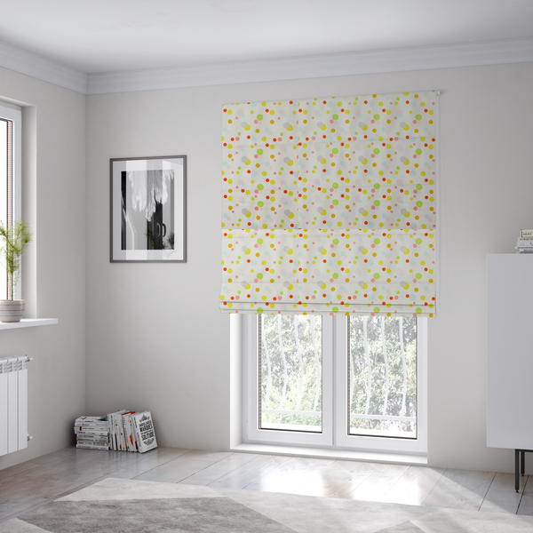 The fabric used to create these Roman blinds is a subtle fabric pattern featuring scattered pastel and bright polka dots in shades of yellow, orange, light green, grey, and soft blue on a white background.