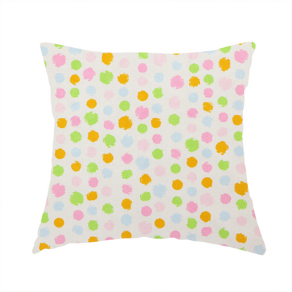 The fabric used to create this handmade cushion is a whimsical fabric pattern featuring scattered painterly dots in soft shades of pink, yellow, lime green, and light blue on a white background.