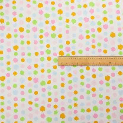 A whimsical fabric pattern featuring scattered painterly dots in soft shades of pink, yellow, lime green, and light blue on a white background.