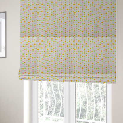The fabric used to create these Roman blinds is a whimsical fabric pattern featuring scattered painterly dots in soft shades of pink, yellow, lime green, and light blue on a white background.