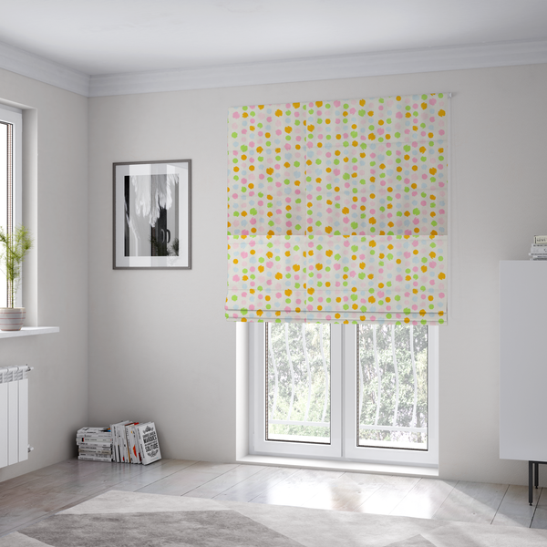 The fabric used to create these Roman blinds is a whimsical fabric pattern featuring scattered painterly dots in soft shades of pink, yellow, lime green, and light blue on a white background.