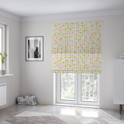The fabric used to create these Roman blinds is a whimsical fabric pattern featuring scattered painterly dots in soft shades of pink, yellow, lime green, and light blue on a white background.