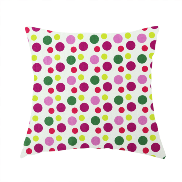 The fabric used to create this handmade cushion is a playful fabric pattern featuring neat vertical rows of alternating polka dots in shades of magenta, pink, green, and lime on a white background.