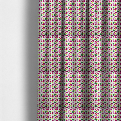 The fabric used to create these made-to-measure curtains is a  playful fabric pattern featuring neat vertical rows of alternating polka dots in shades of magenta, pink, green, and lime on a white background.