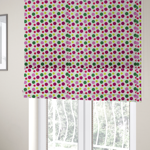 The fabric used to create these Roman blinds is a playful fabric pattern featuring neat vertical rows of alternating polka dots in shades of magenta, pink, green, and lime on a white background.