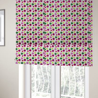 The fabric used to create these Roman blinds is a playful fabric pattern featuring neat vertical rows of alternating polka dots in shades of magenta, pink, green, and lime on a white background.