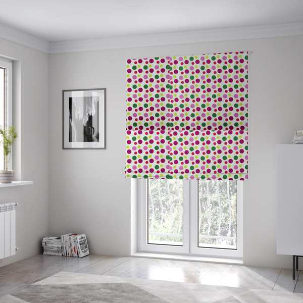 The fabric used to create these Roman blinds is a playful fabric pattern featuring neat vertical rows of alternating polka dots in shades of magenta, pink, green, and lime on a white background.
